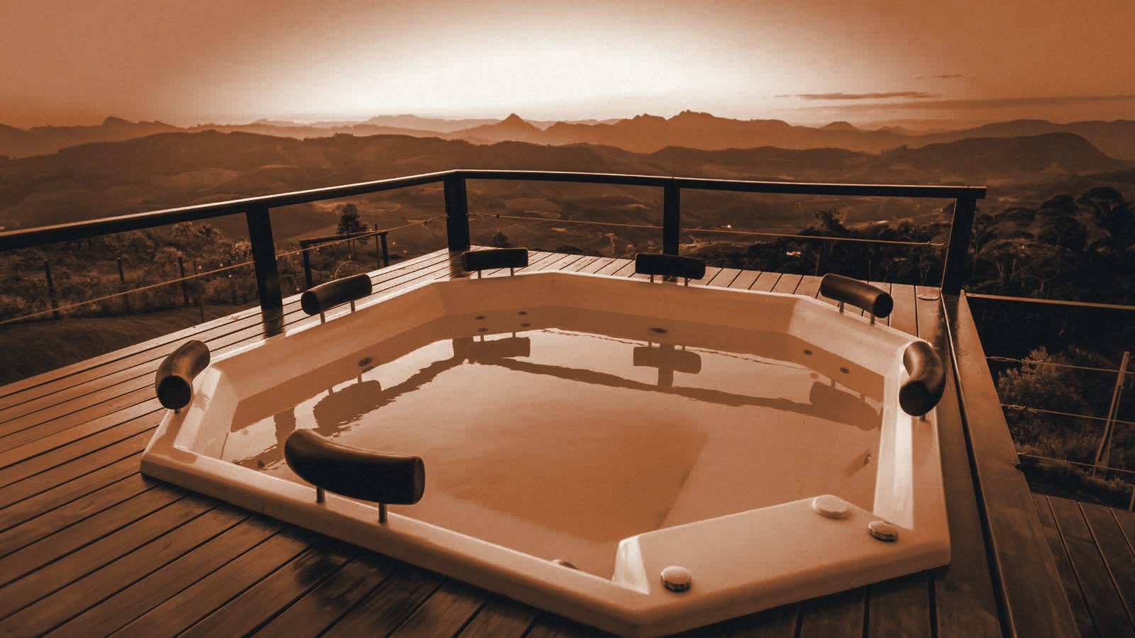 Copper duotone of a hot tub on a mountain deck at sunrise